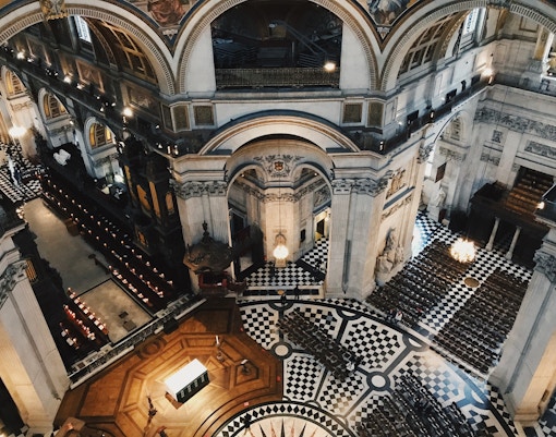 Interior view of St. Paul's Cathedral in London, showcasing ornate architecture and checkered floor.