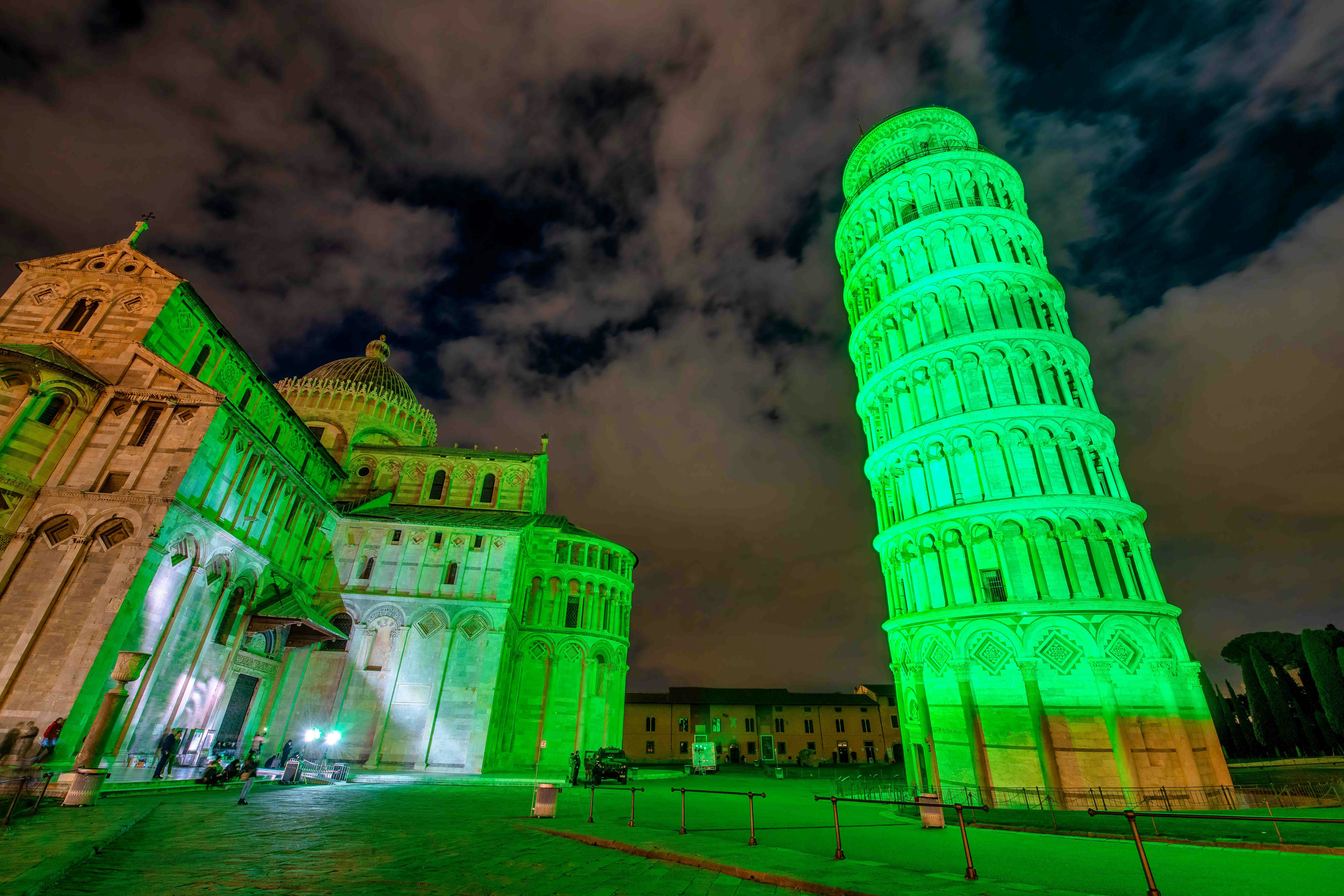 Leaning Tower of Pisa illuminated green for St. Patrick’s Day, Florence in March.