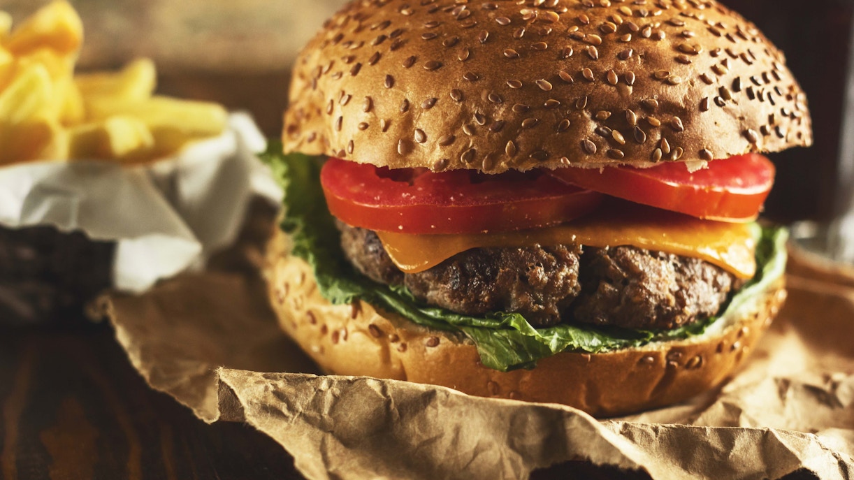 Burgers and French fries served at a food stall.