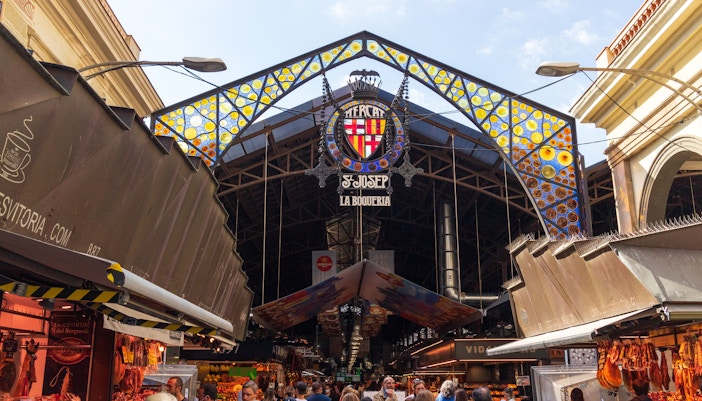 La Boqueria market stalls with fresh produce and vibrant colors in Barcelona, Spain.