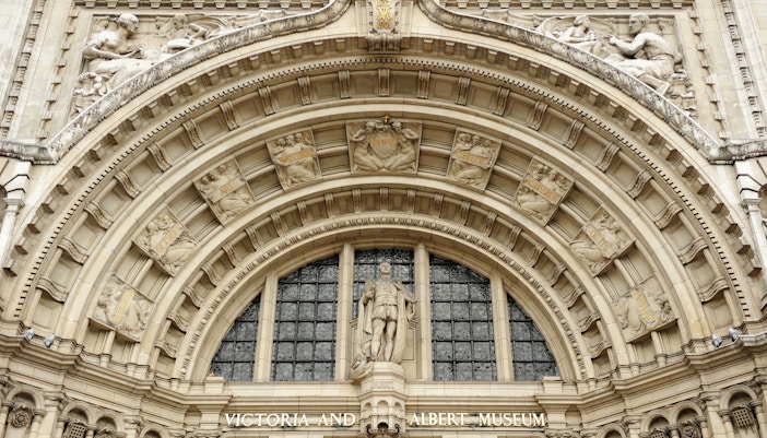 Victoria and Albert Museum entrance arch with detailed sculptures, London.