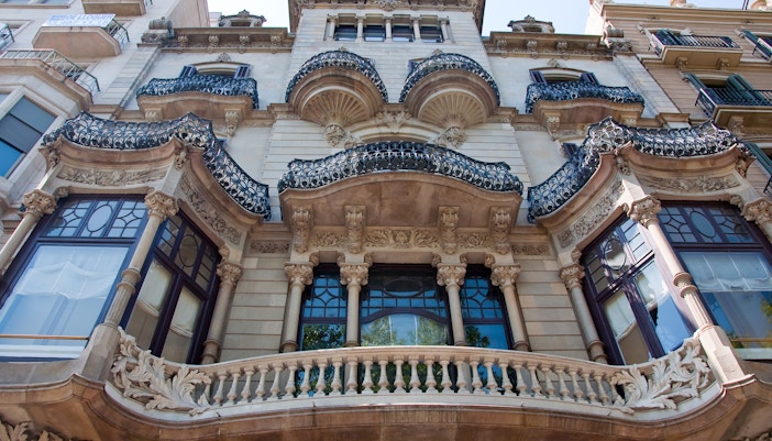 Passeig de Gràcia shoppers walking past luxury boutiques in Barcelona.