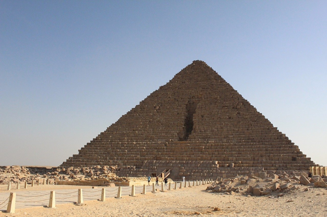 Pyramid of Menkaure at Giza with tourists exploring the site.