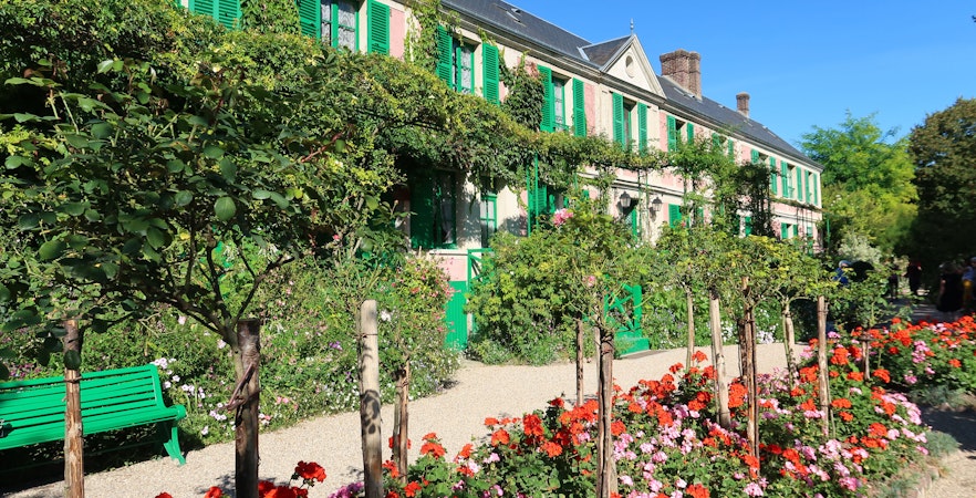 Pathway and garden at Musée de la Vie Romantique, Paris, with vibrant flowers and greenery.