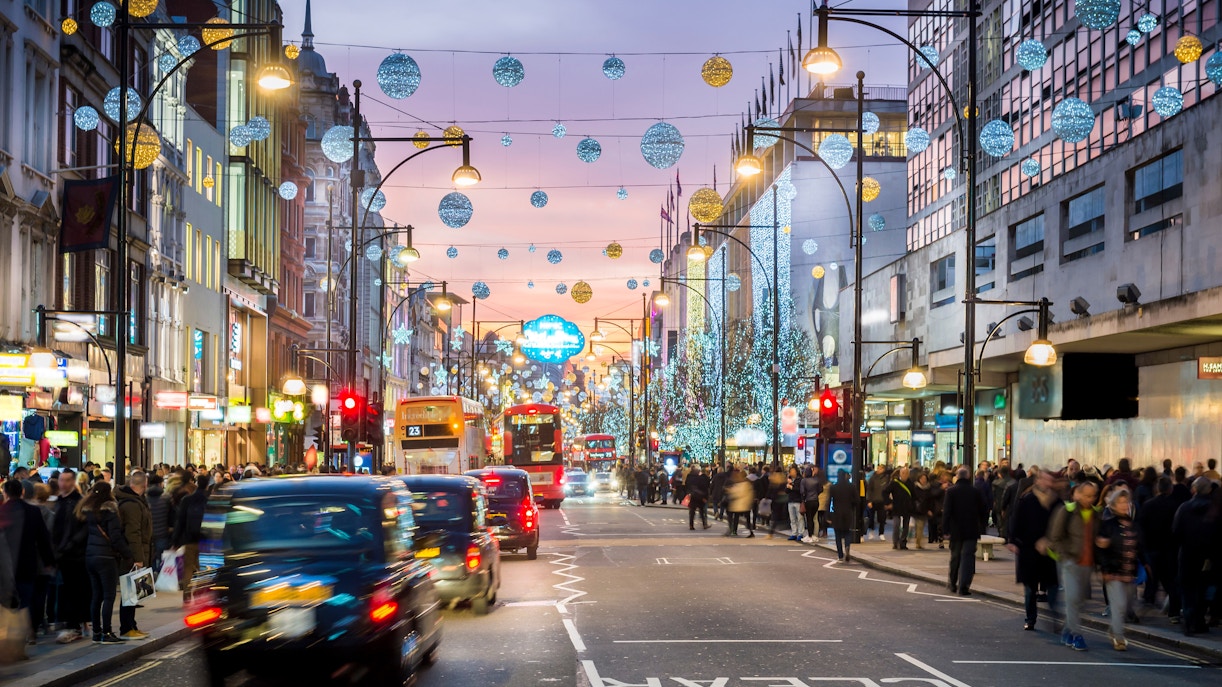 Oxford Street in London with evening shoppers and festive lights.