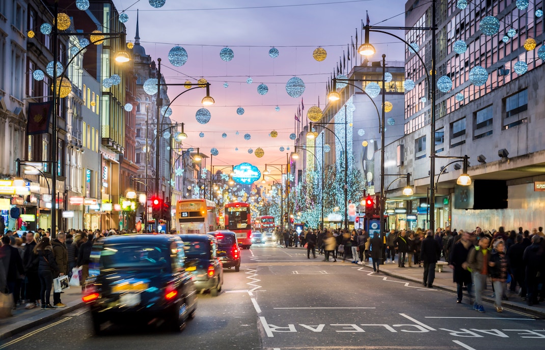 Oxford Street in London with evening shoppers and festive lights.