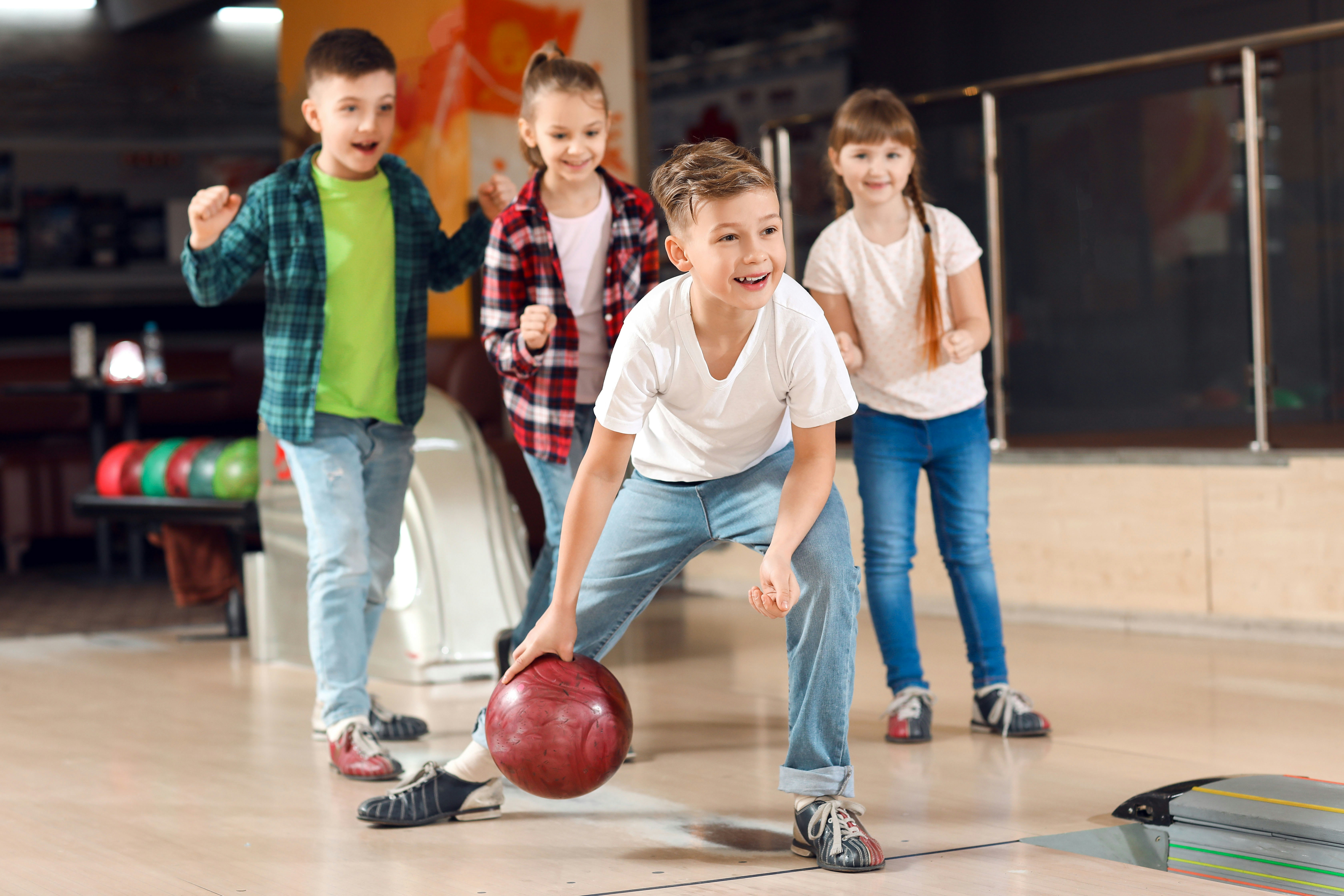 Children bowling at an indoor arena