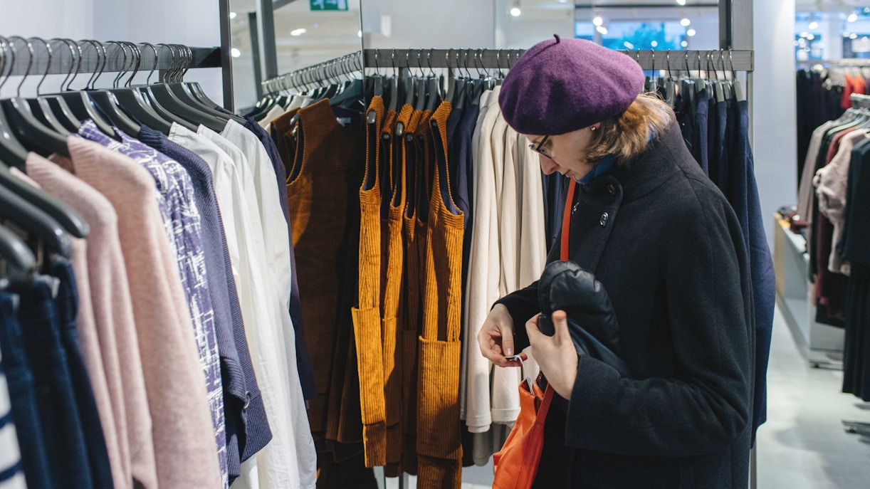 Le Marais Parisian street with boutique shops and pedestrians shopping.