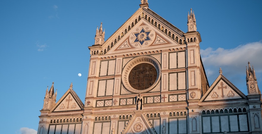 Santa Croce Basilica facade under blue sky, Florence.
