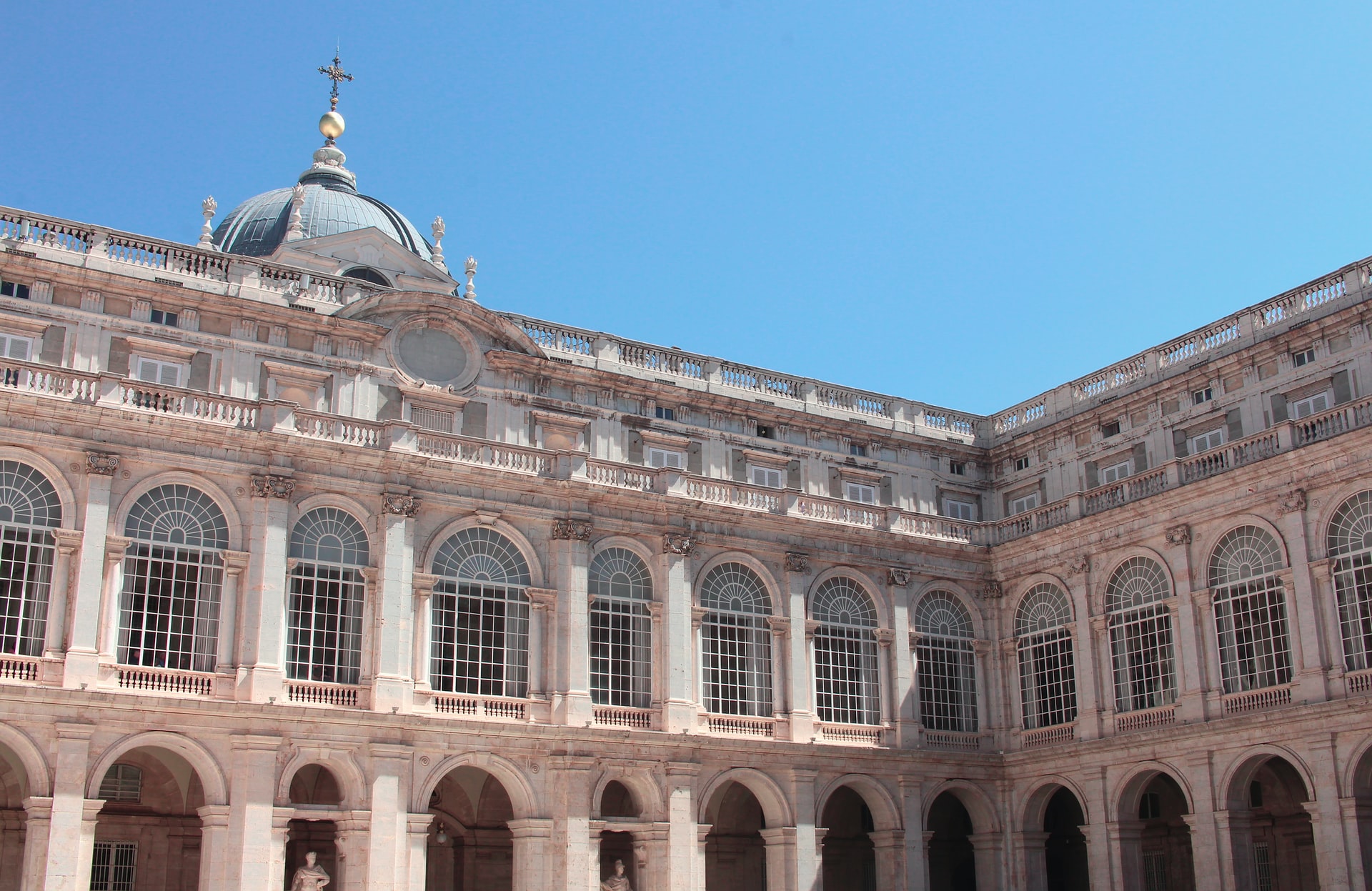 Royal Palace Madrid exterior with arched windows and dome.