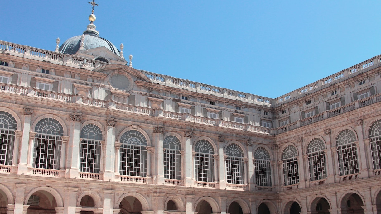 Royal Palace Madrid exterior with arched windows and dome.