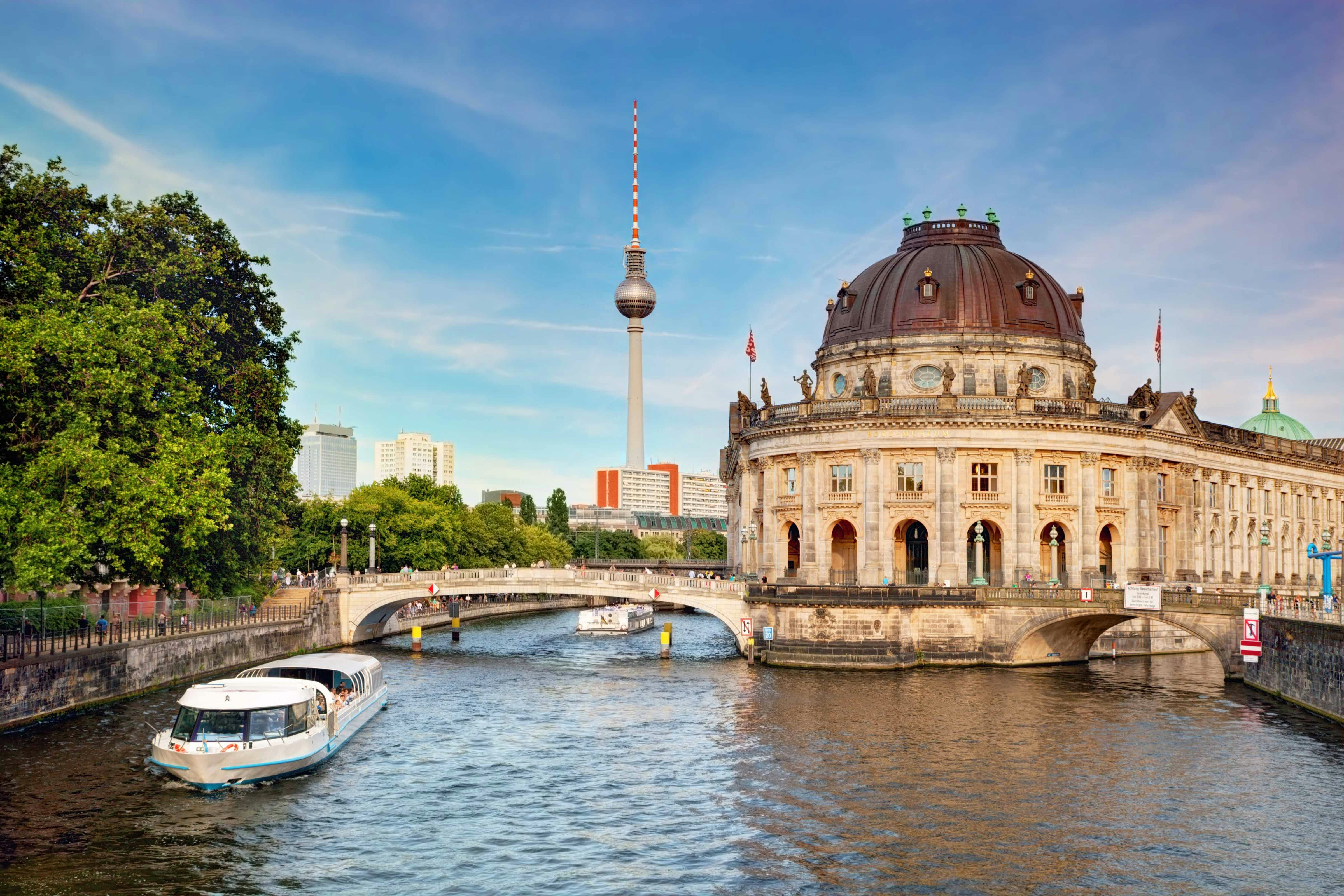 Boat cruising near Berlin's Museum Island with TV Tower in the background.