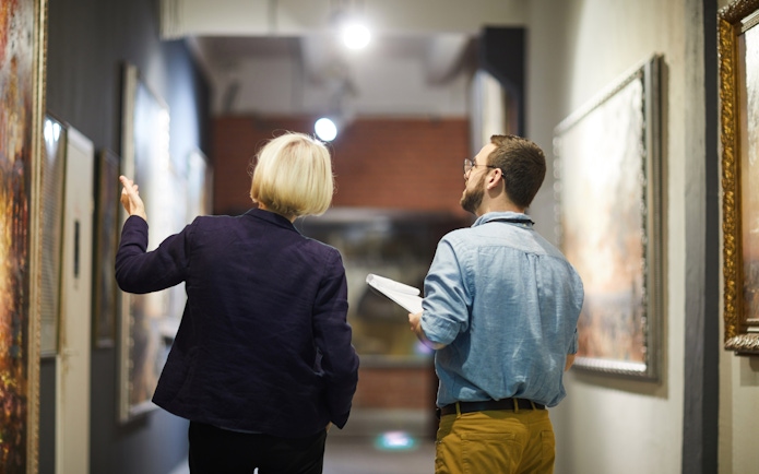 Guided tour at Doge's Palace with visitors viewing artwork.