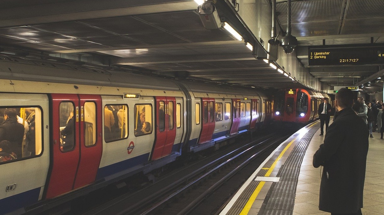 London Underground train at a busy station platform.