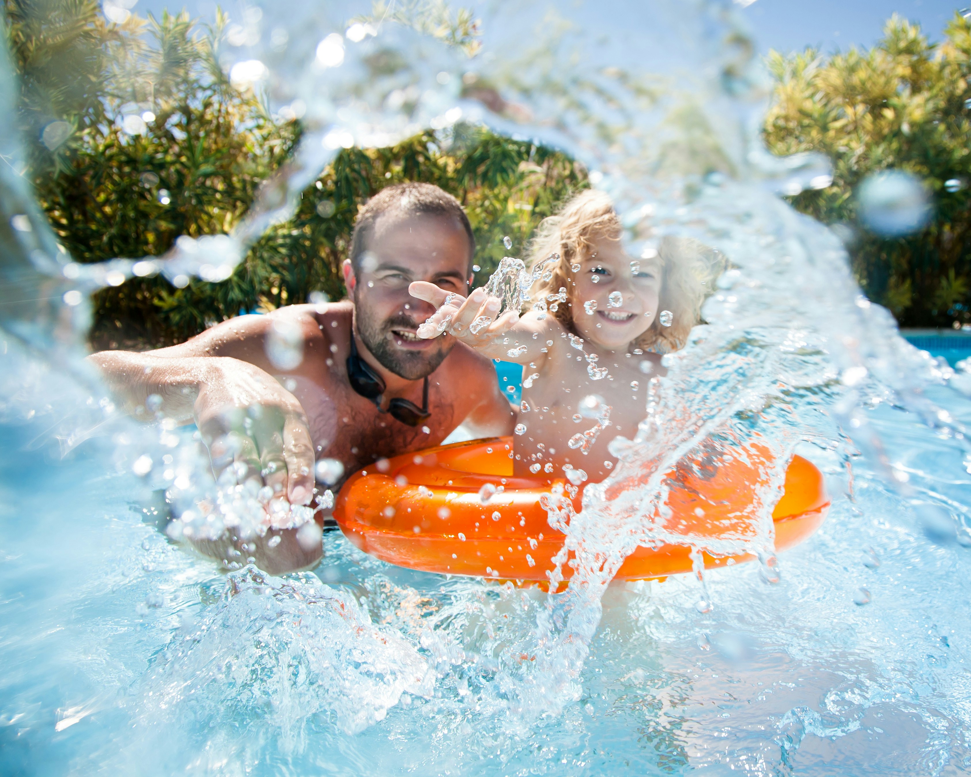 Father and child enjoying LEGO® Wave Pool at Dubai LEGOLAND Water Park.