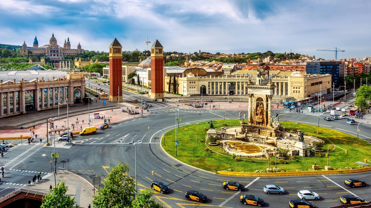 Barcelona Hop-on Hop-off bus at Plaça d'Espanya with view of Venetian Towers.