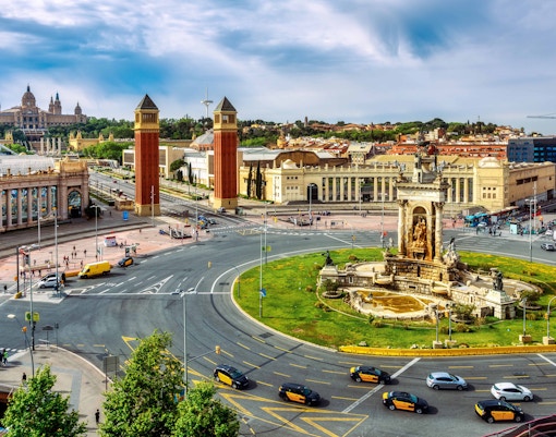Barcelona Hop-on Hop-off bus at Plaça d'Espanya with view of Venetian Towers.