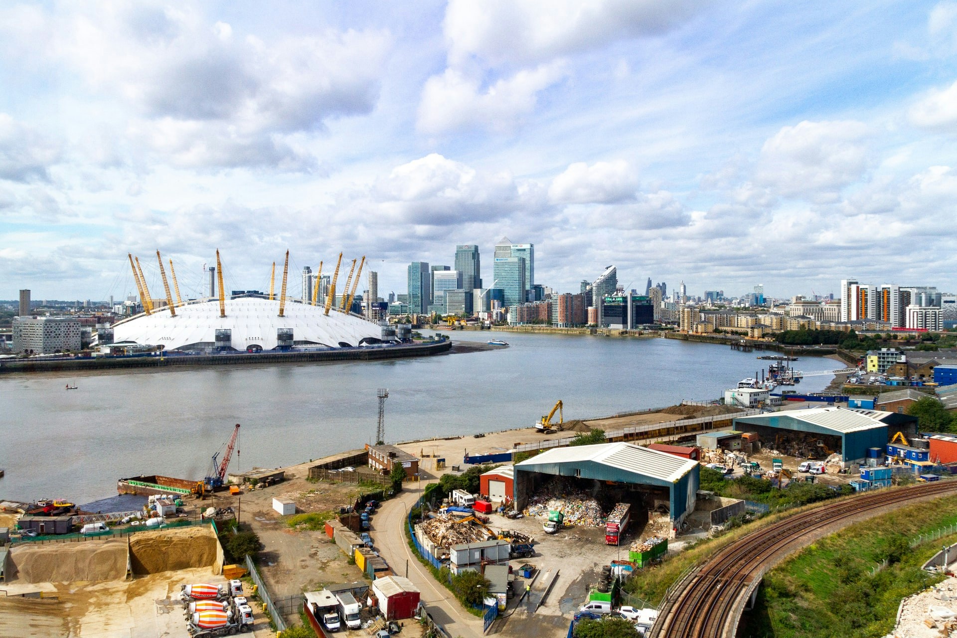 O2 Arena and Canary Wharf skyline across the River Thames in London.