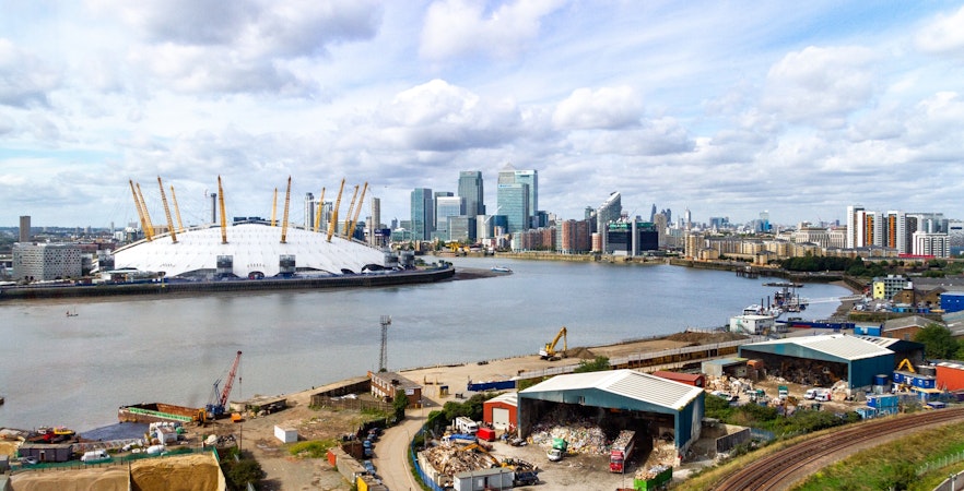 O2 Arena and Canary Wharf skyline across the River Thames in London.