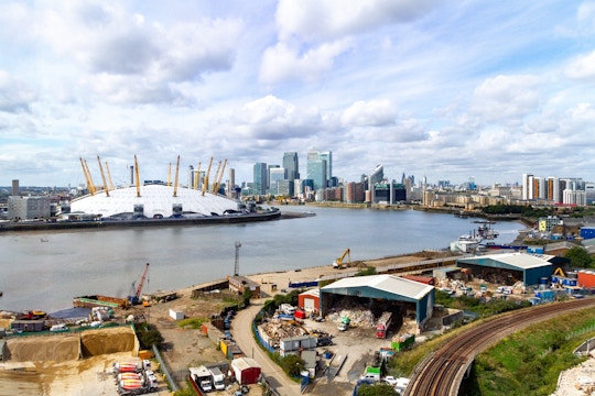 O2 Arena and Canary Wharf skyline across the River Thames in London.