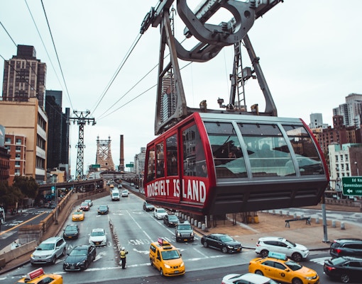 Roosevelt Island Tram over East River with NYC skyline, Valentine's Day experience.
