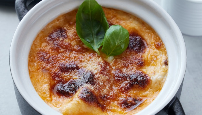 Eiffel Tower view with a table set for a Parisian meal, showcasing Paris food experience.