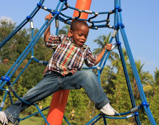 Child climbing rope structure at Nestopia, Singapore.