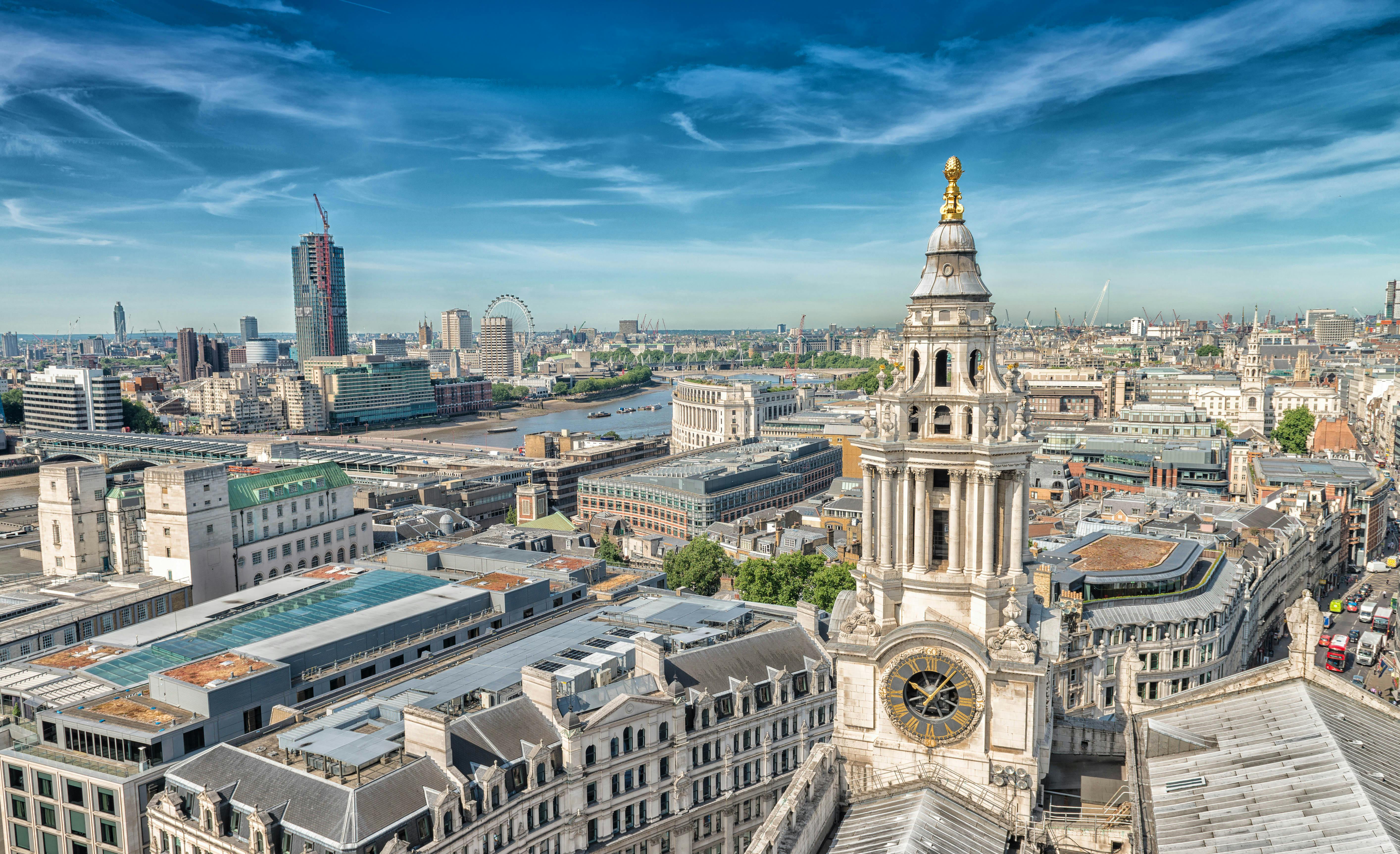 Aerial view of St. Paul's Cathedral in London with the city skyline and River Thames.