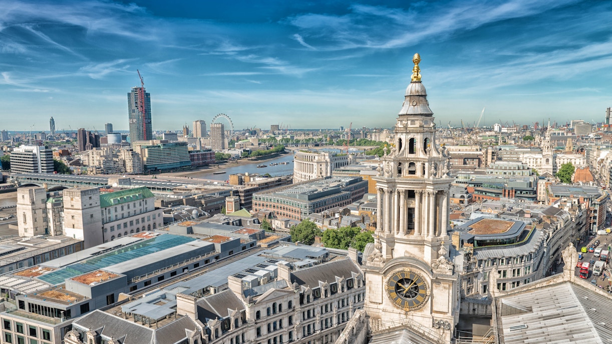 Aerial view of St. Paul's Cathedral in London with the city skyline and River Thames.