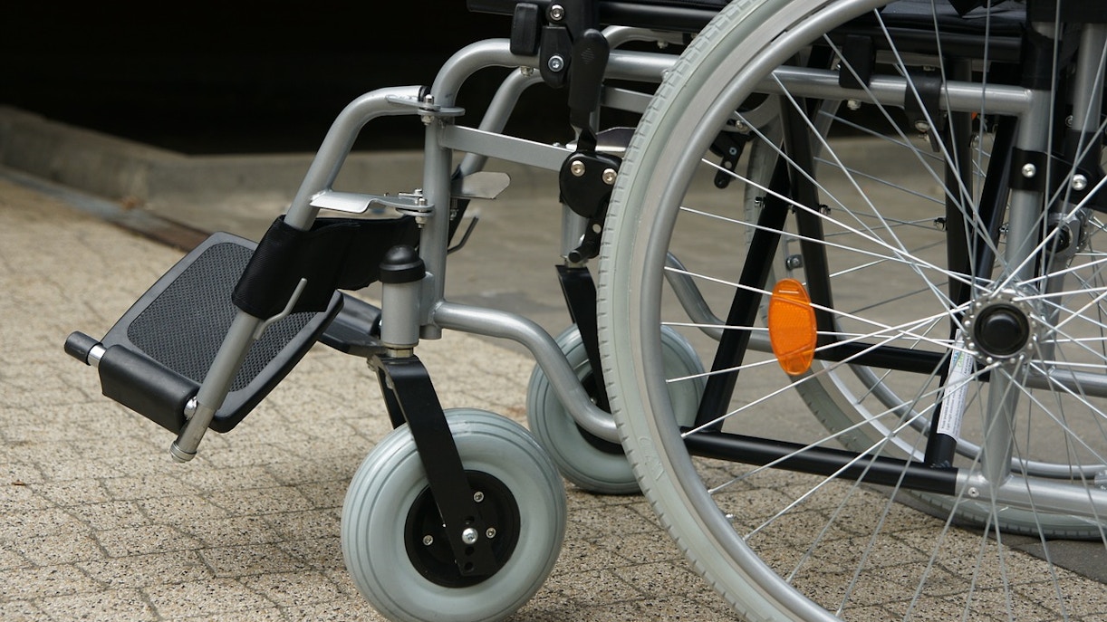 Wheelchair on a paved surface, highlighting accessibility features.
