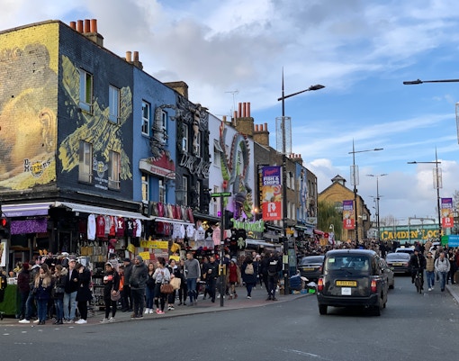 Camden Market stalls with shoppers exploring unique London souvenirs.