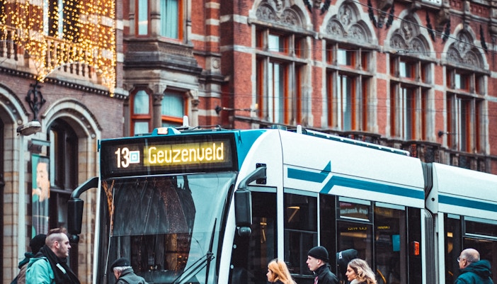 Amsterdam tram passing by Moco Museum entrance.