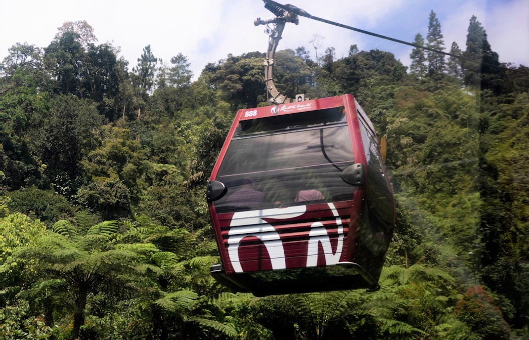 Genting Cable Car gondola ascending through lush green mountains in Malaysia.
