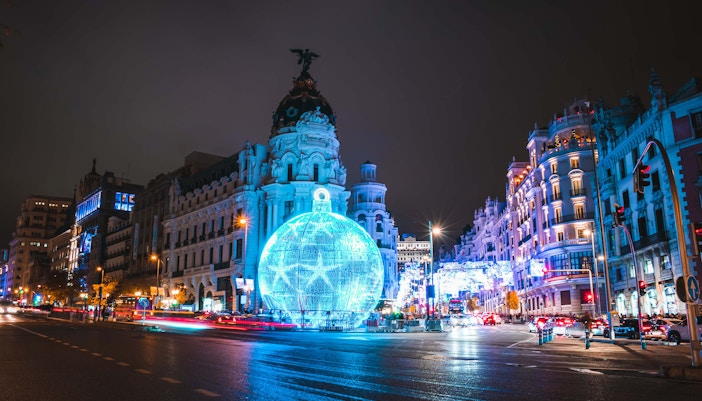 Madrid's Gran Vía illuminated with festive lights in December.