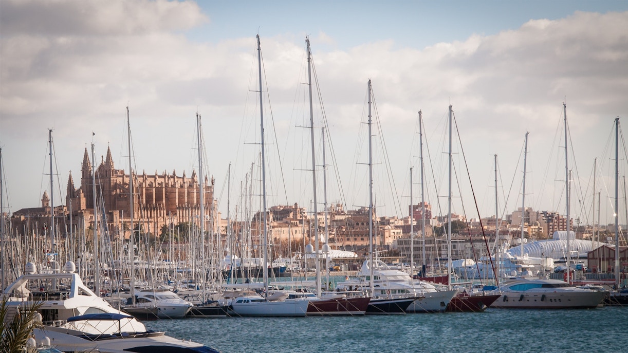 Sailboat anchored in a serene bay with clear blue waters in Mallorca.