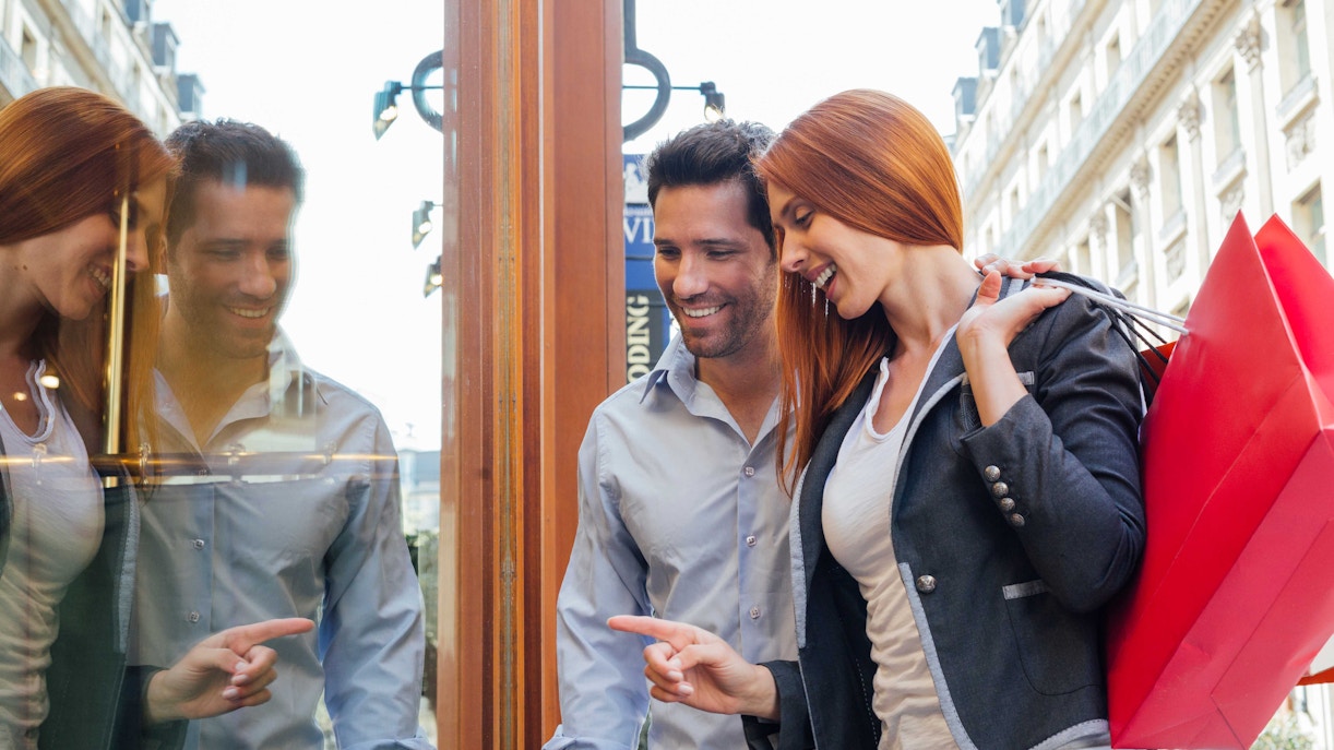 La Vallée Village Paris shopping street with designer stores and visitors exploring.