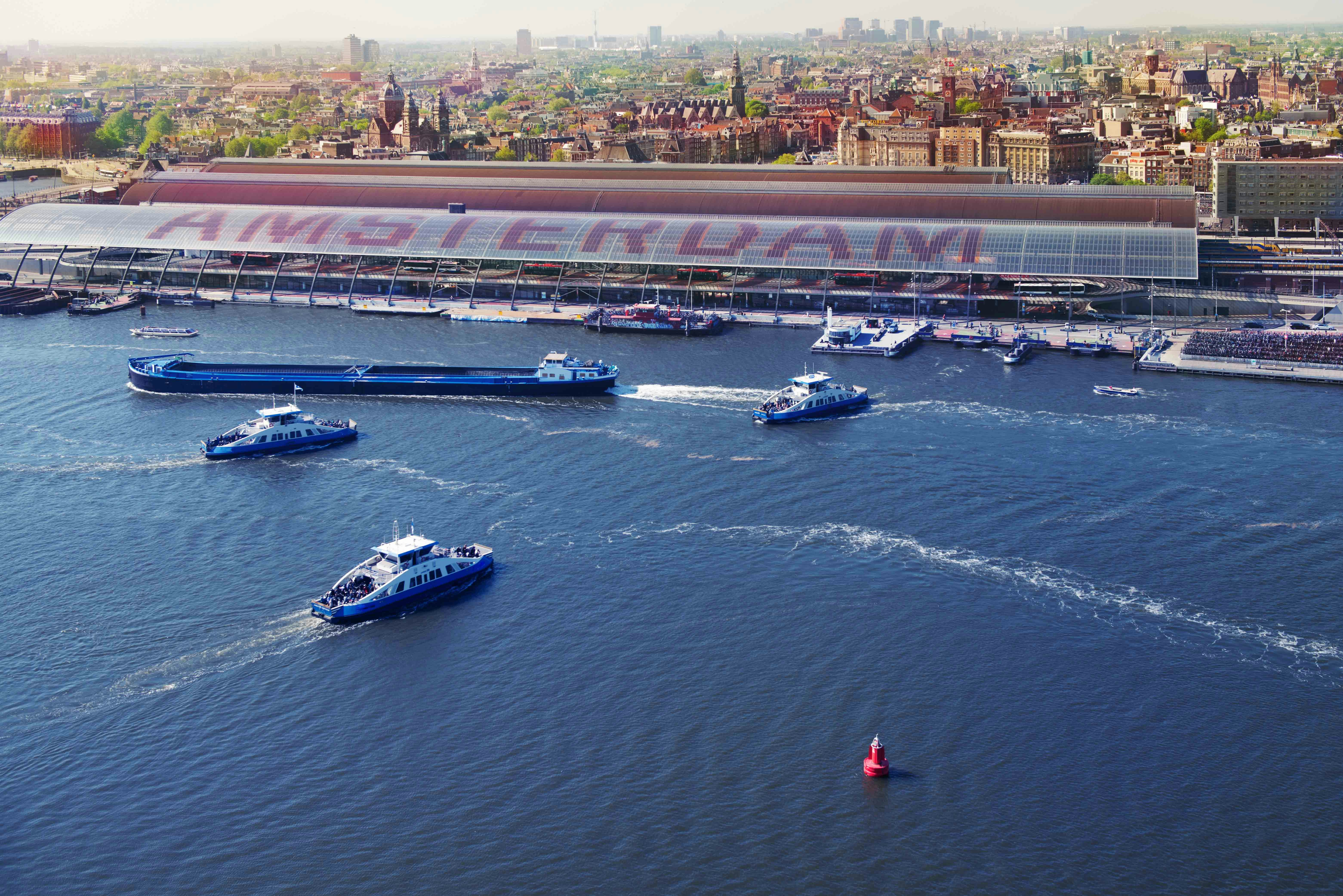 Ferries on the IJ River near Amsterdam Central Station, part of the Volendam-Marken Express route.
