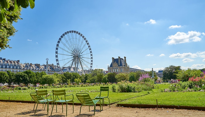 Jardin des Tuileries in Paris with people strolling along tree-lined paths.