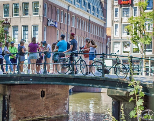 Anne Frank House exterior with visitors on Amsterdam walking tour.