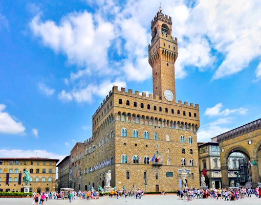 Palazzo Vecchio in Florence with tourists in April.