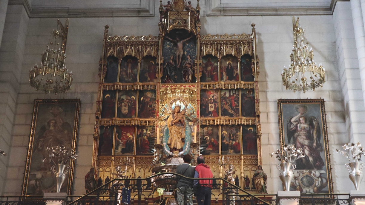 Sagrada Familia altar with intricate carvings and stained glass windows in Barcelona, Spain.