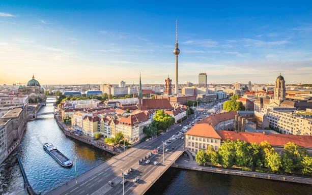 Berlin skyline with TV Tower and boat on Spree River near Nikolaiviertel.