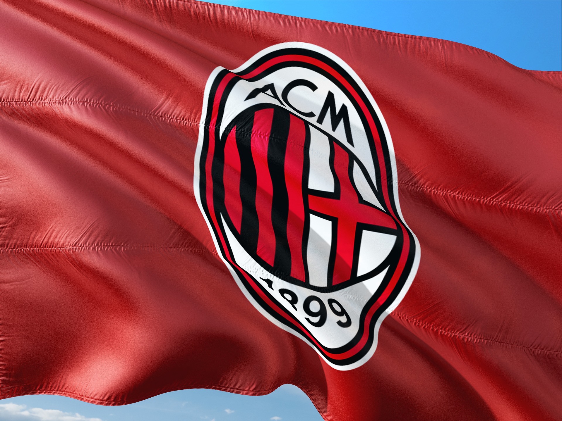 AC Milan flag waving, featuring club emblem, related to Soccer International.