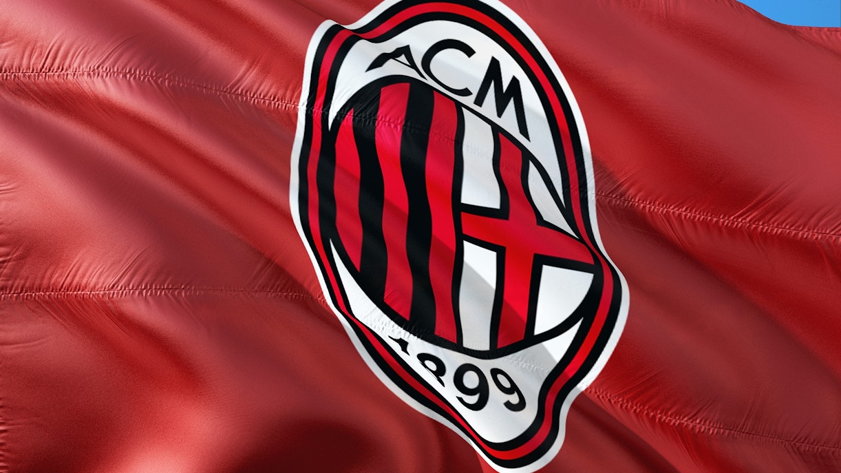 AC Milan flag waving, featuring club emblem, related to Soccer International.