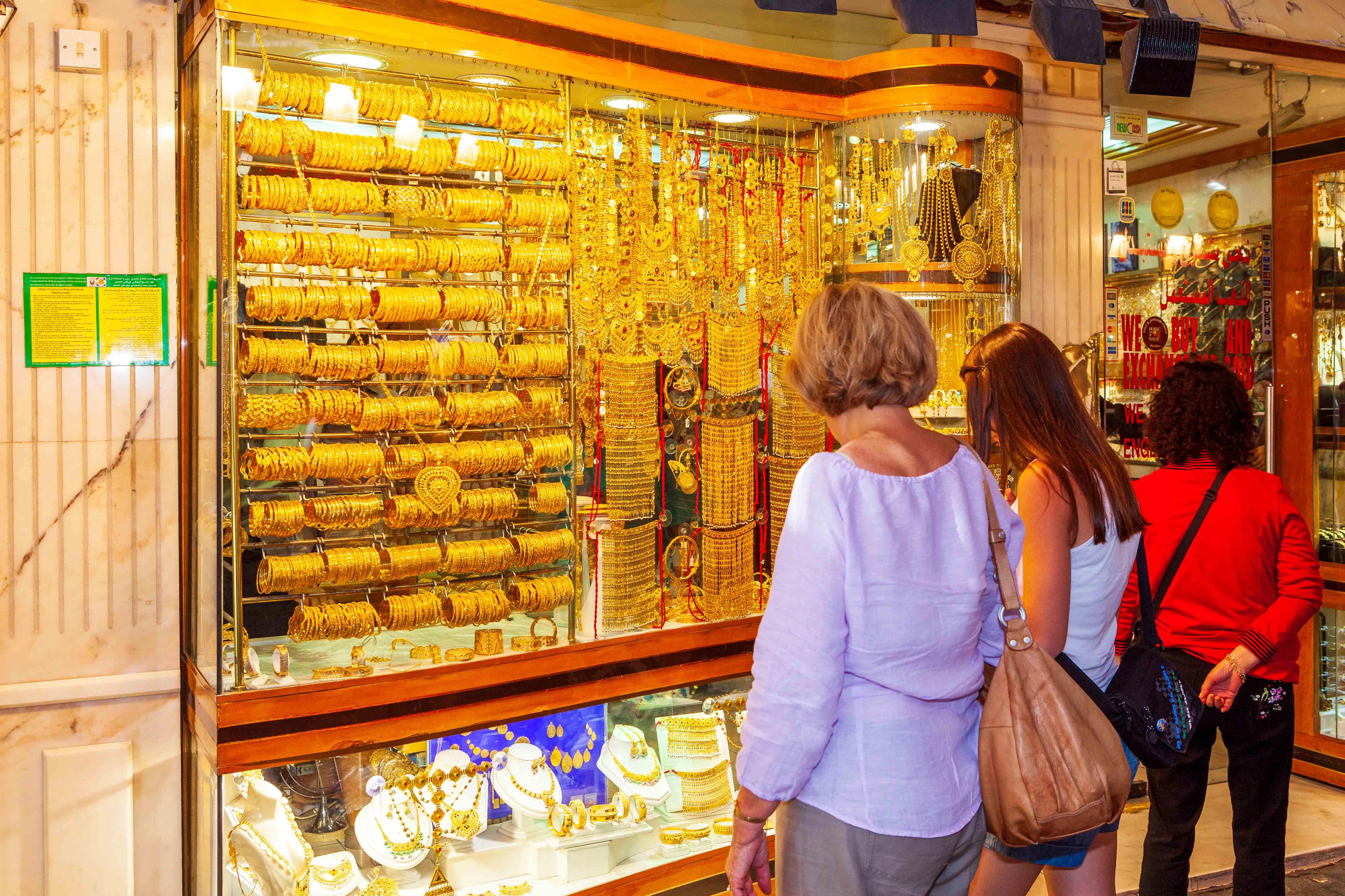 Shoppers browsing gold jewelry at Dubai's Gold Souk.