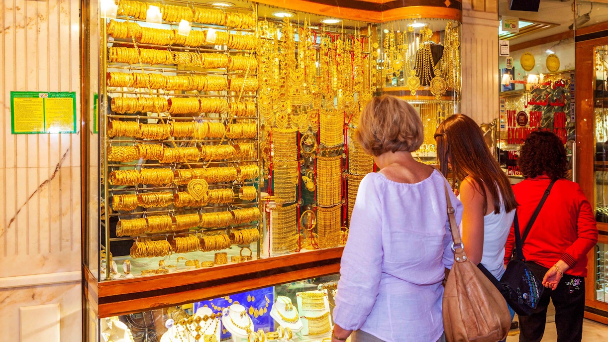 Gold Souk in Dubai with vibrant gold jewelry displays and bustling shoppers.
