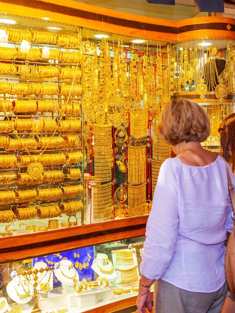 Shoppers browsing gold jewelry at Dubai's Gold Souk.