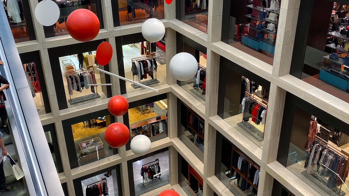 Rinascente Roma Tritone shopping center interior with people browsing stores in Rome, Italy.