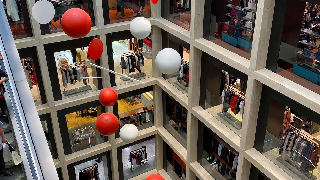 Rinascente Roma Tritone shopping center interior with people browsing stores in Rome, Italy.