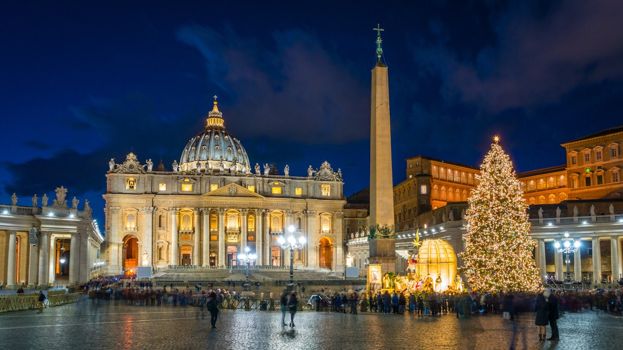 St. Peter's Basilica and Christmas tree in Vatican City, Rome during winter evening.